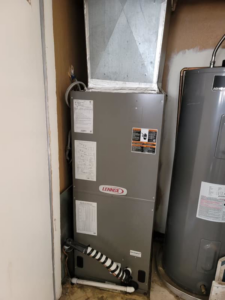 A Lennox indoor HVAC air handler unit installed next to a water heater by B3 Refrigeration LLC in Tempe, AZ