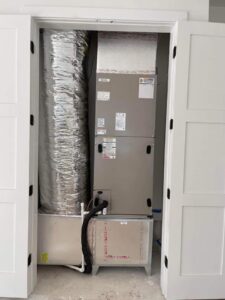 Indoor HVAC air handler unit and ductwork installed in a closet by Huggins Mechanical in Jacksonville, FL