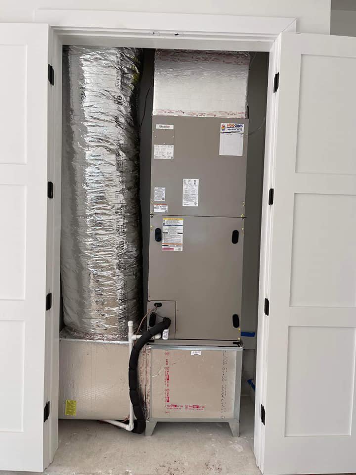 Indoor HVAC air handler unit and ductwork installed in a closet by Huggins Mechanical in Jacksonville, FL