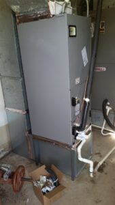 An indoor HVAC air handler unit with ductwork connections, installed by R&B Cooling&Heating in Abbeville, LA.