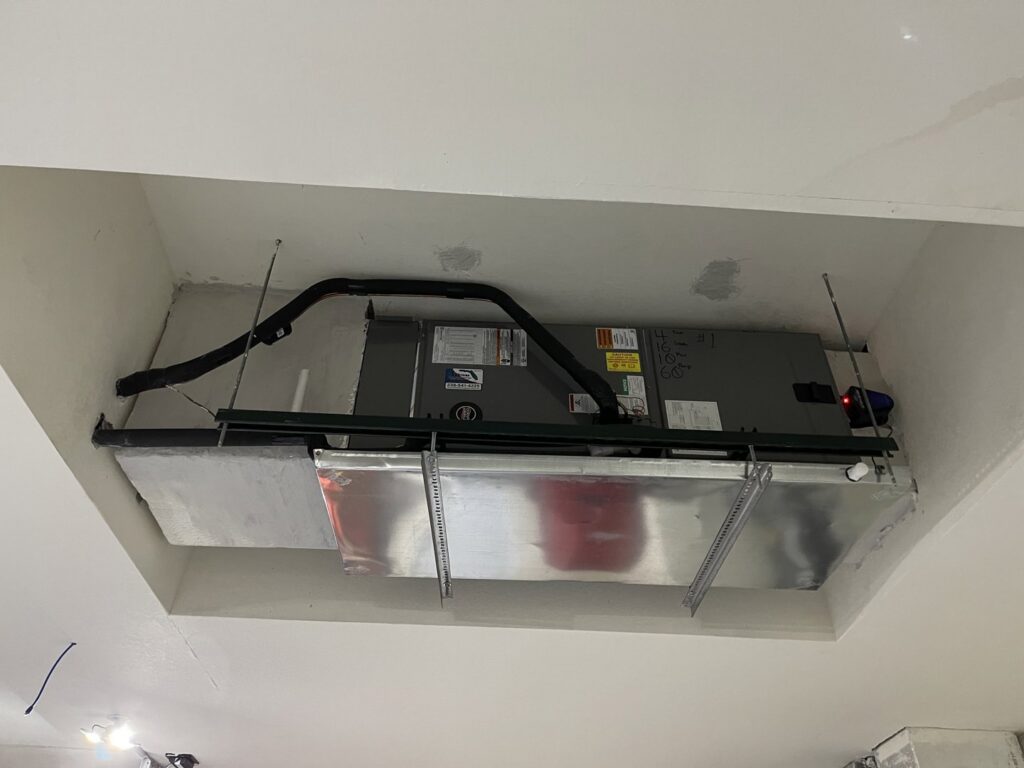 An indoor HVAC air handler unit installed in a ceiling space by Surfside Heating & Cooling in Cape Coral, FL.