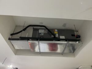 An indoor HVAC air handler unit installed in a ceiling space by Surfside Heating & Cooling in Cape Coral, FL.