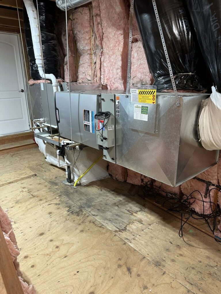 An indoor HVAC air handler unit and ductwork installation by The Heating Specialist in Portland, OR