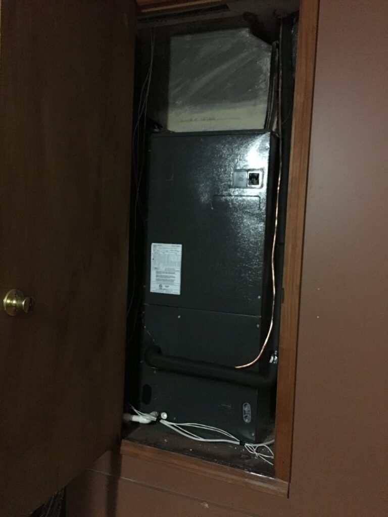 An indoor HVAC air handler unit installed in a utility closet by Air Control Heating and Cooling in Tallahassee, FL.