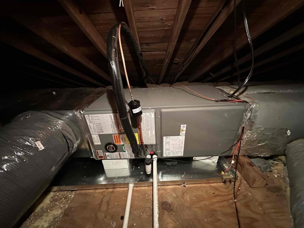 An indoor HVAC air handler unit with ductwork installed by Miller's Home Comfort-Chesapeake in Chesapeake, VA.