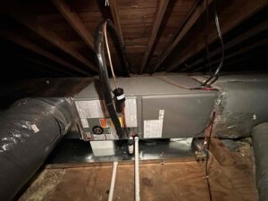 An indoor HVAC air handler unit with ductwork installed by Miller's Home Comfort-Chesapeake in Chesapeake, VA.