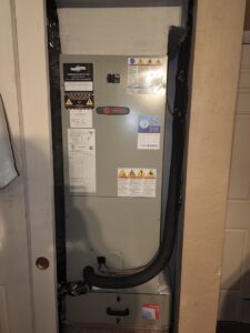 An indoor HVAC air handler unit with Air Zero service stickers in a closet in Largo, FL