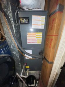 An indoor HVAC air handler unit with ductwork installed by Wilcox Services in Temple Hills, MD.