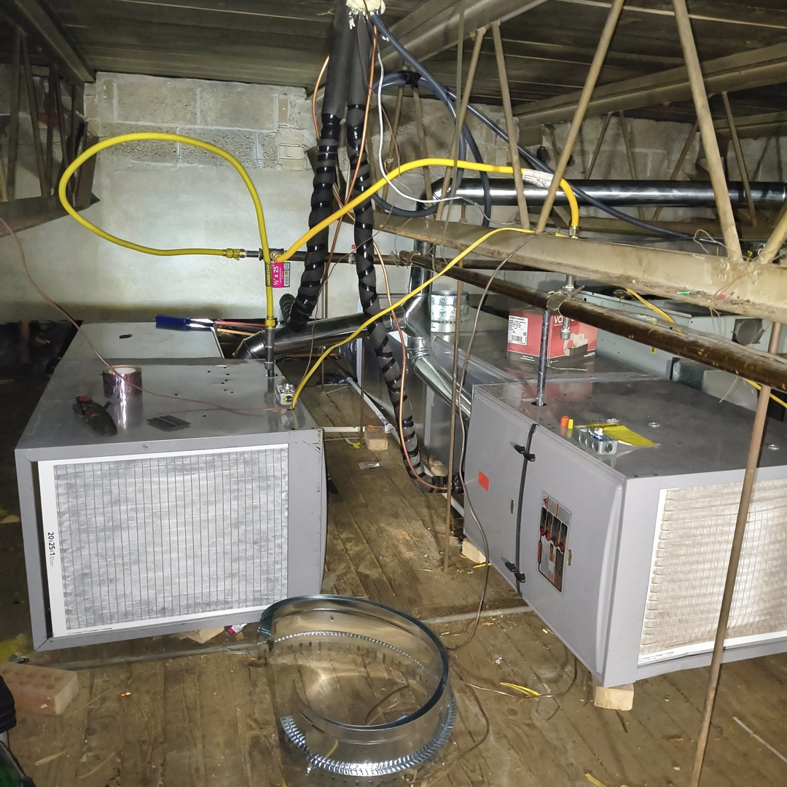 Two indoor HVAC air handler units with ductwork connections installed by Aaron's Affordable Ac in Indianapolis, IN.