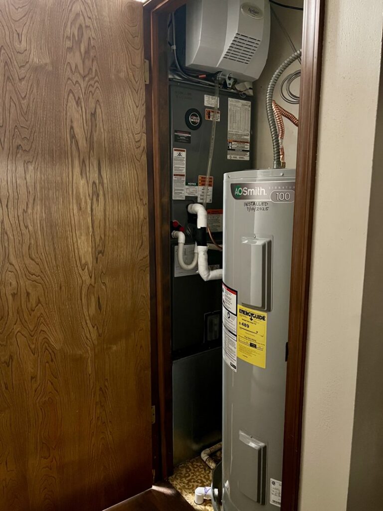 An indoor HVAC air handler unit in a utility closet, serviced by Symbiont Services in Englewood, FL.