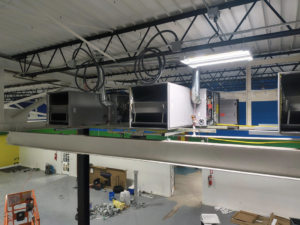 Indoor HVAC air handler units and ductwork installed on a beam by Aaron's Affordable Ac in Indianapolis, IN.
