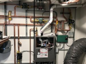 Indoor HVAC and boiler system installation with extensive copper piping by Central Heating & Air in Sioux Falls, SD