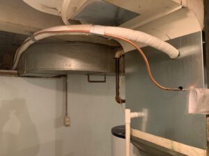 Indoor HVAC ductwork and insulated copper lines connected to an air handler or furnace by Matt Moeller Heating and Cooling Llc in Stewartville, MN