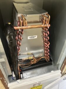An indoor HVAC evaporator coil unit, showing components serviced by Air Advisors of Louisiana in Shreveport, LA.
