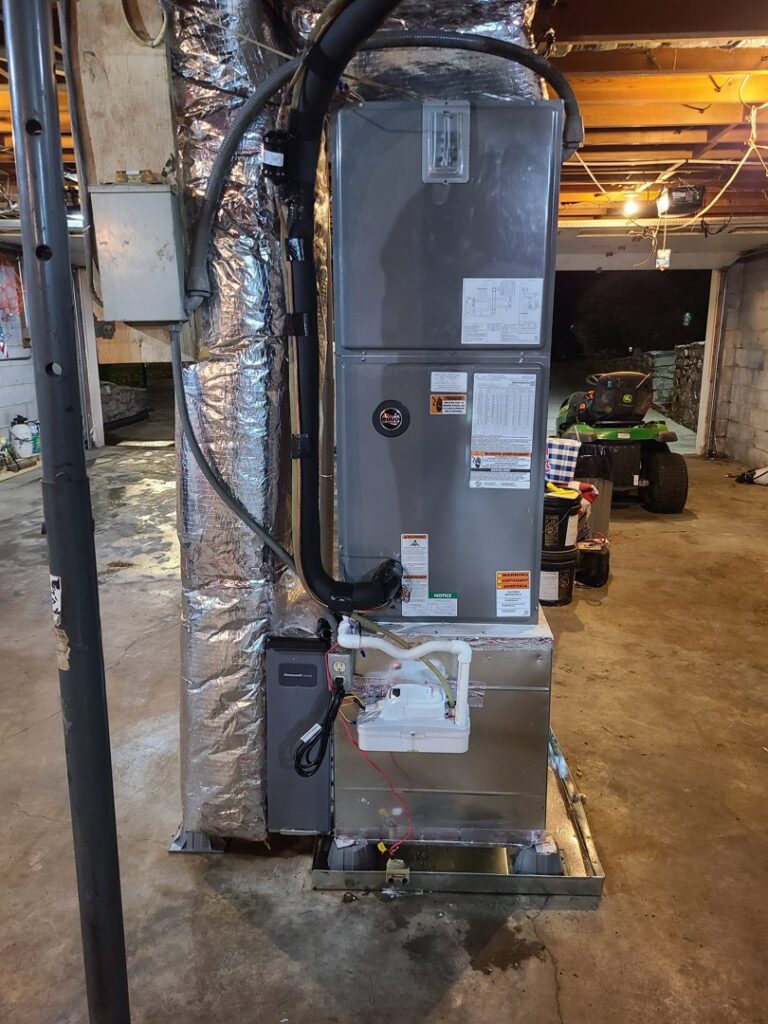 An indoor HVAC furnace and air handler unit with ductwork installed by Adam's Air Conditioning & Heating in Rockvale, TN