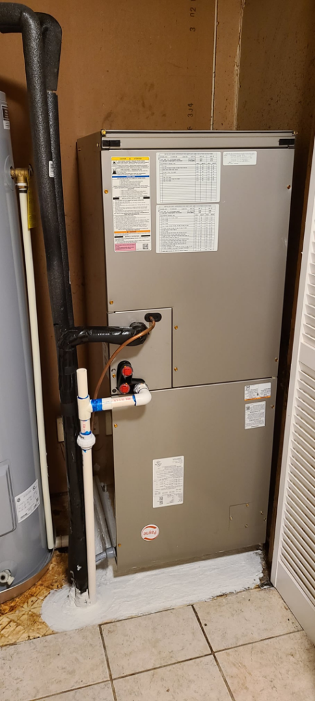 An indoor HVAC furnace and air handler system installed in a utility closet by Air Mechanics, LLC in Greensboro, NC.