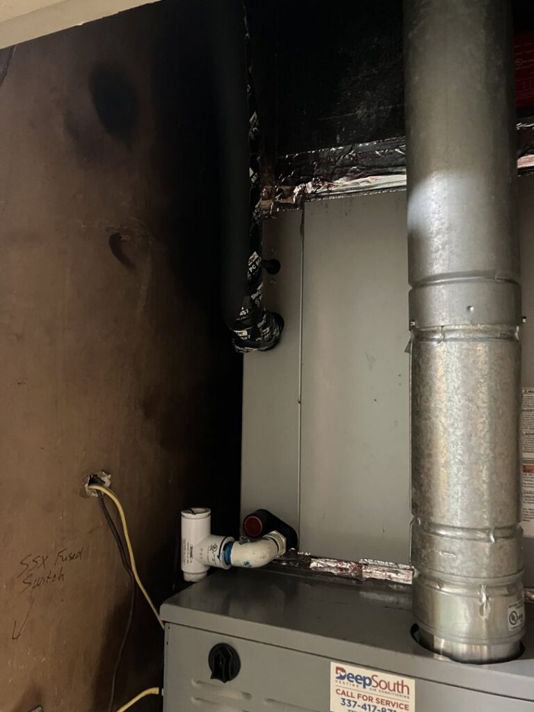 An indoor HVAC furnace and air handler unit with connected ductwork, representing services by AirHero.Pro in Lafayette, LA.