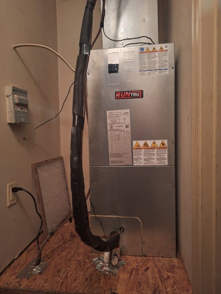 An indoor HVAC furnace and air handler unit with ductwork and electrical connections, serviced by Summit Service Heating and Air in Hilton Head Island, SC.