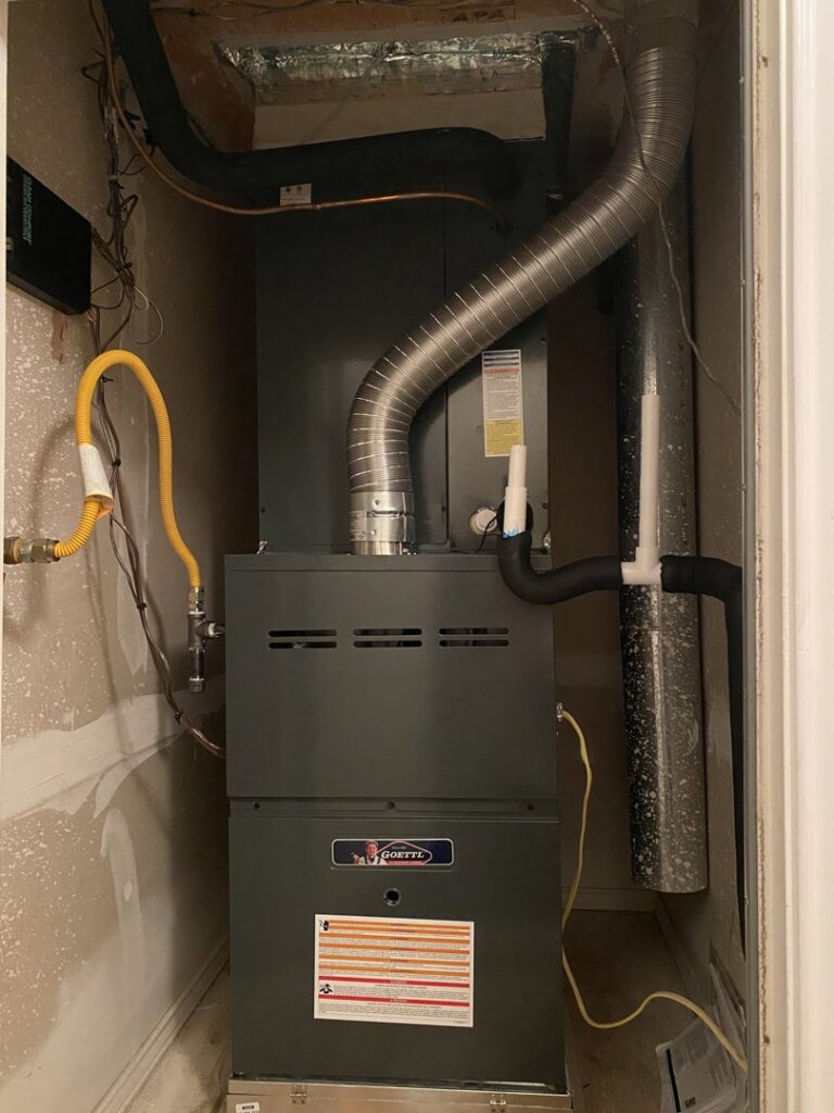 An indoor HVAC furnace unit installed in a utility closet by Goettl Austin in Austin, TX