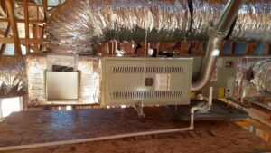 An indoor HVAC furnace unit with insulated ductwork installed in an attic by S&S Mechanical in St. George, UT