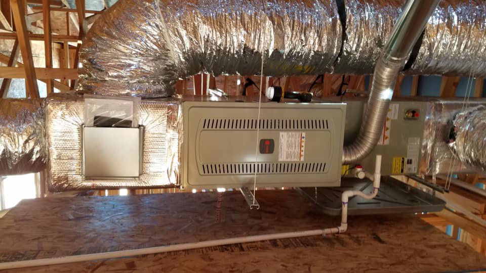 An indoor HVAC furnace unit with insulated ductwork installed in an attic by S&S Mechanical in St. George, UT