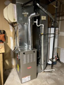 An indoor HVAC furnace with a humidifier and water heater installed by Rescue Heating and Air Conditioning in Manassas, VA
