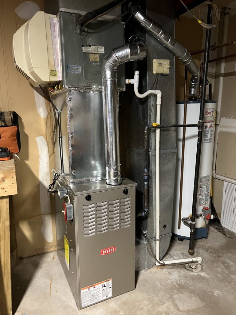 An indoor HVAC furnace with a humidifier and water heater installed by Rescue Heating and Air Conditioning in Manassas, VA