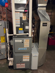 An indoor HVAC furnace and air handler unit with ductwork installed by Berkshire Heating and Cooling in Pittsburgh, PA