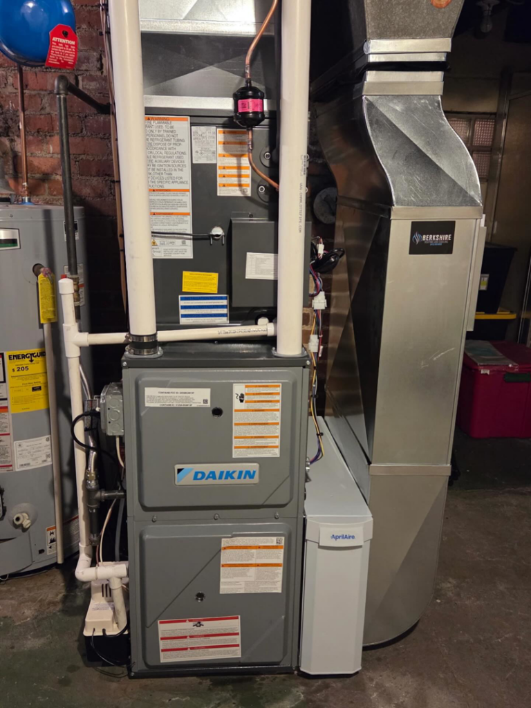 An indoor HVAC furnace and air handler unit with ductwork installed by Berkshire Heating and Cooling in Pittsburgh, PA
