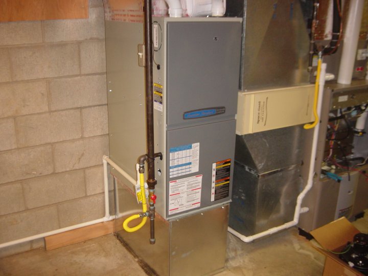 An indoor HVAC furnace system with ductwork and gas lines installed by F & S Williams in Lafayette, IN.