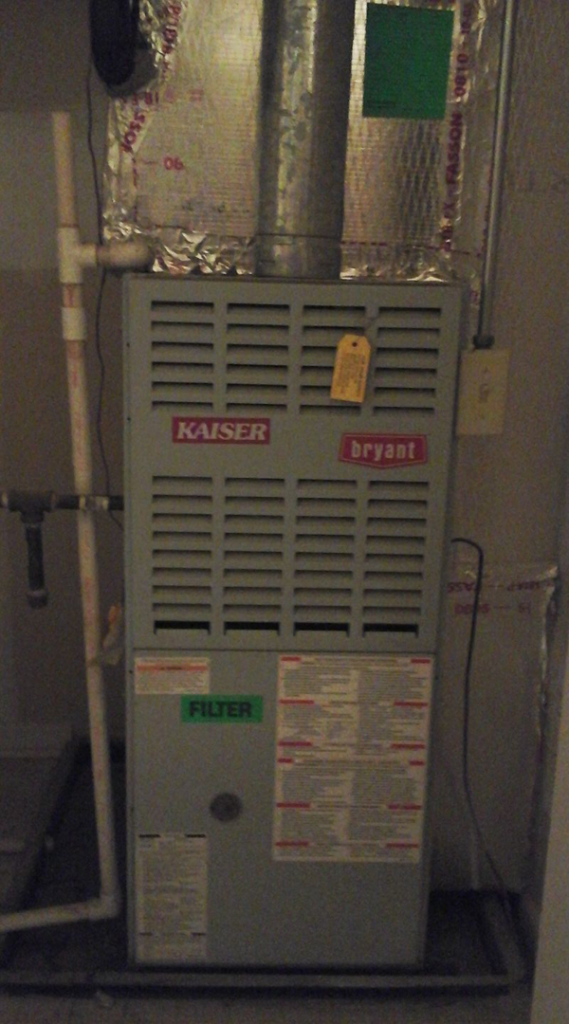 An indoor HVAC furnace unit with a filter reminder sticker, serviced by Harbrecht HVAC in Fishers, IN.