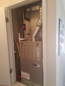 An indoor Carrier HVAC furnace unit installed by Anderson Refrigeration, Inc. in Poplar Grove, IL.
