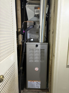 An indoor Payne HVAC furnace unit installed in a utility closet by Pepper Mechanical in Pittsburgh, PA