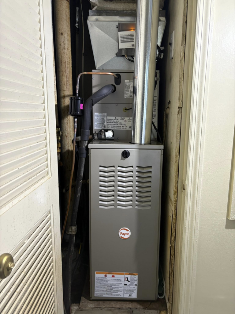 An indoor Payne HVAC furnace unit installed in a utility closet by Pepper Mechanical in Pittsburgh, PA