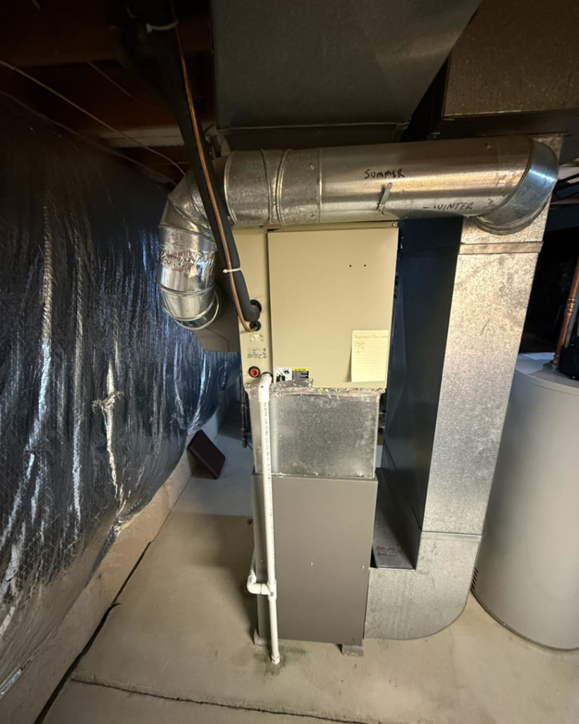 An indoor HVAC furnace unit installed by Progressive Heating and Cooling WNY in Buffalo, NY.