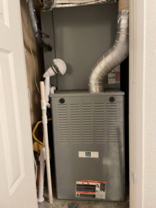 An indoor HVAC furnace unit installed in a utility closet, ready for service by Blue Collar Mechanical LLC in Indianapolis, IN.