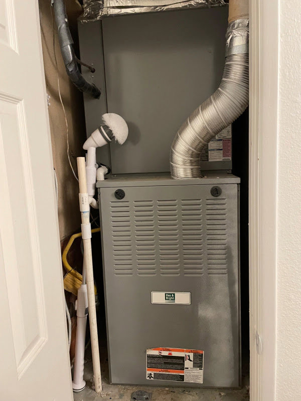 An indoor HVAC furnace unit installed in a utility closet, ready for service by Blue Collar Mechanical LLC in Indianapolis, IN.