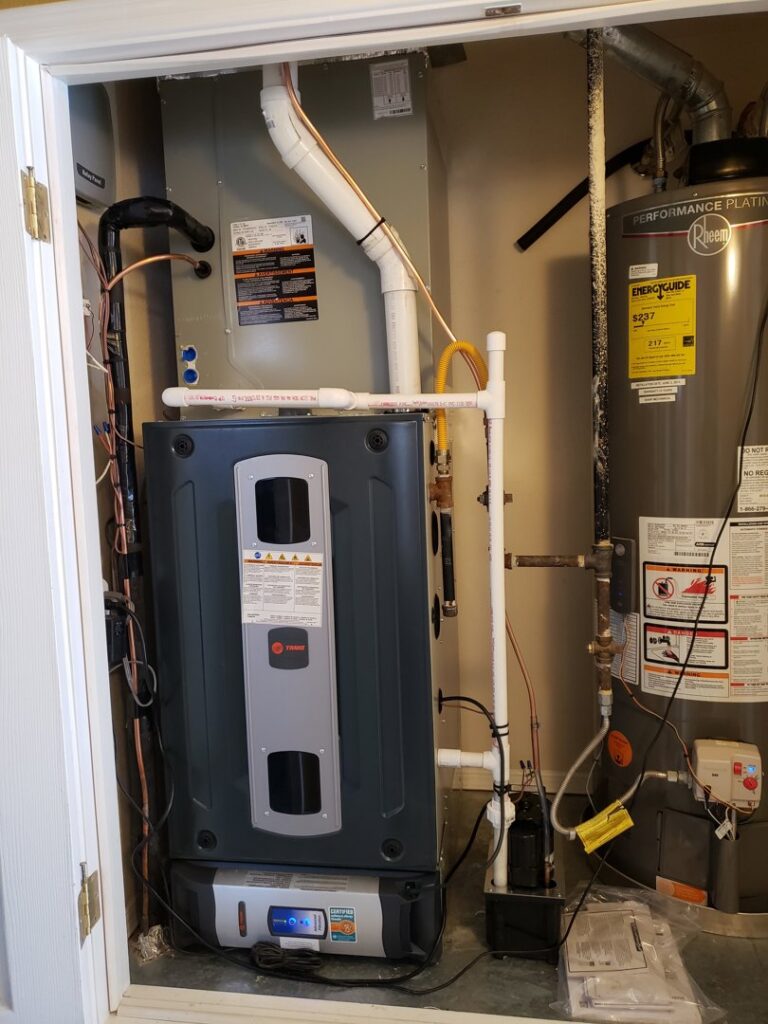 An indoor HVAC furnace and water heater installation in a utility closet by Dynamic Heating, Cooling, Refrigeration & Roofing in El Paso, TX.