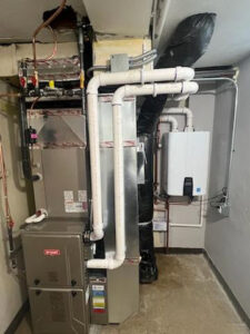 An indoor HVAC furnace and water heater installation with ductwork and piping by Supreme Stands in Maple Grove, MN
