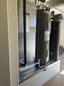 An indoor HVAC furnace unit installed next to a water heater by Larson Air Conditioning in Scottsdale, AZ