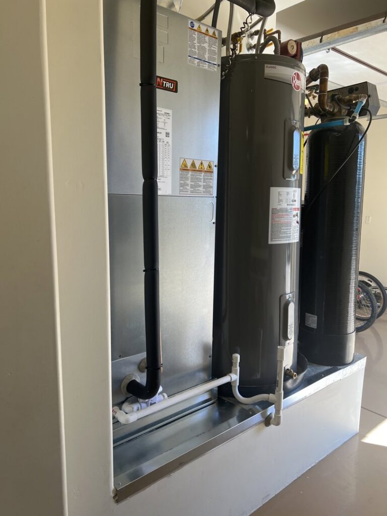 An indoor HVAC furnace unit installed next to a water heater by Larson Air Conditioning in Scottsdale, AZ