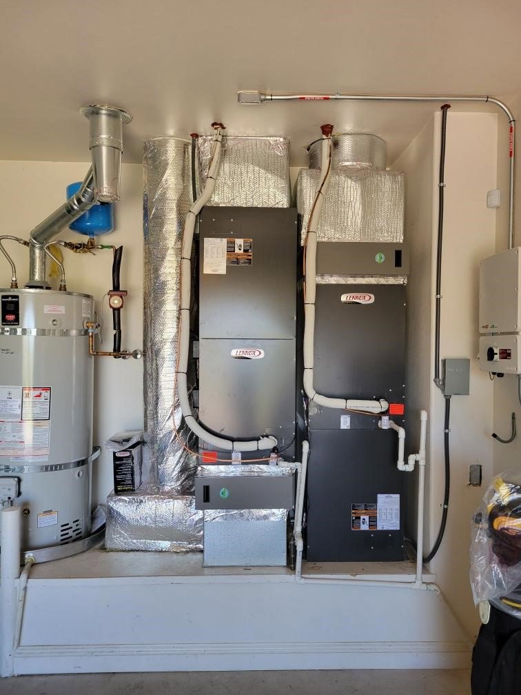 An indoor HVAC system with a furnace and water heater installed by DeHart Plumbing, Heating, & Air in Sparks, NV.