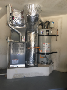 A complete indoor HVAC system with furnace, water heater, and ductwork installed by HVAC Logistics in Albuquerque, NM