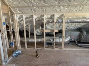 An indoor HVAC system with ductwork and insulation being installed in an attic by Freedom Air Mechanical Contractors LLC in Everett, MA.