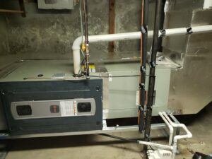 An indoor HVAC system with ductwork installed in a basement by Dynamic Heating, Cooling, Refrigeration & Roofing in El Paso, TX.