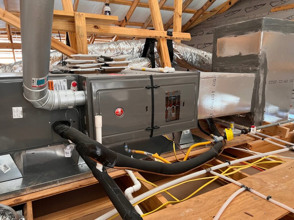 An indoor HVAC system, including a furnace and ductwork, being installed by Johnson's A/C & Heating in Alexandria, LA.