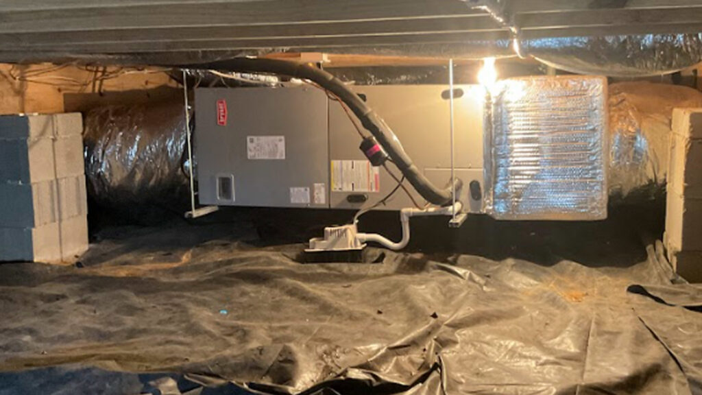 An indoor HVAC unit, likely a furnace or air handler, installed in a crawl space by Top Notch Heating and Air Conditioning in Bowling Green, KY.
