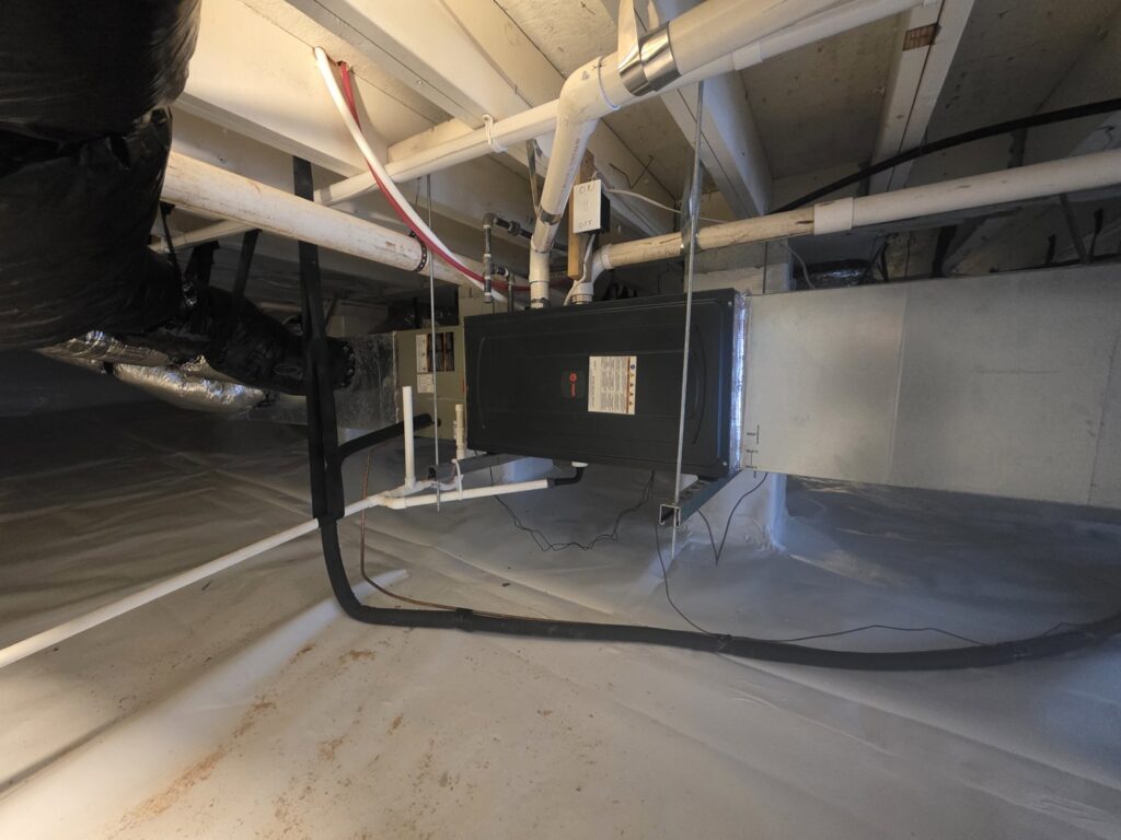 An indoor HVAC unit and ductwork installed in a clean crawl space by Sizemore Heating & Air, LLC in Chapel Hill, NC