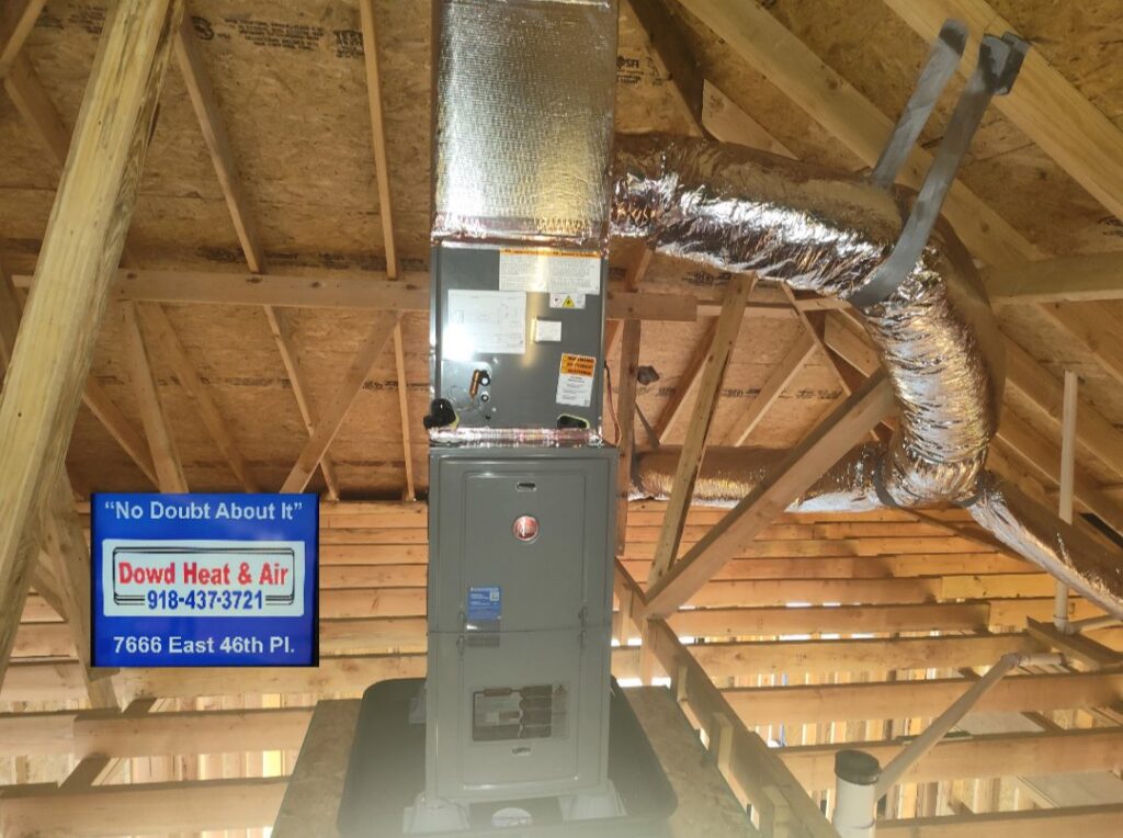An indoor HVAC unit and flexible ductwork installed in an attic by Dowd Heat & Air in Tulsa, OK.