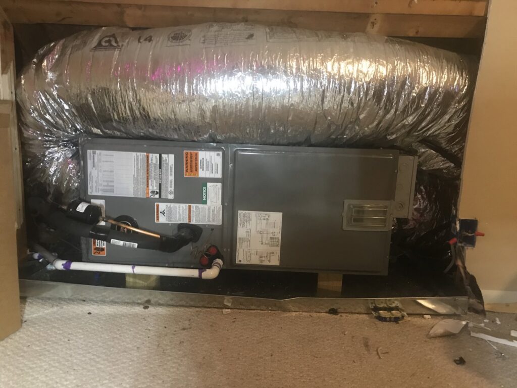 An indoor HVAC unit with insulated ductwork installed in a residential space by Gouker's Best Air in Franklin, TN.